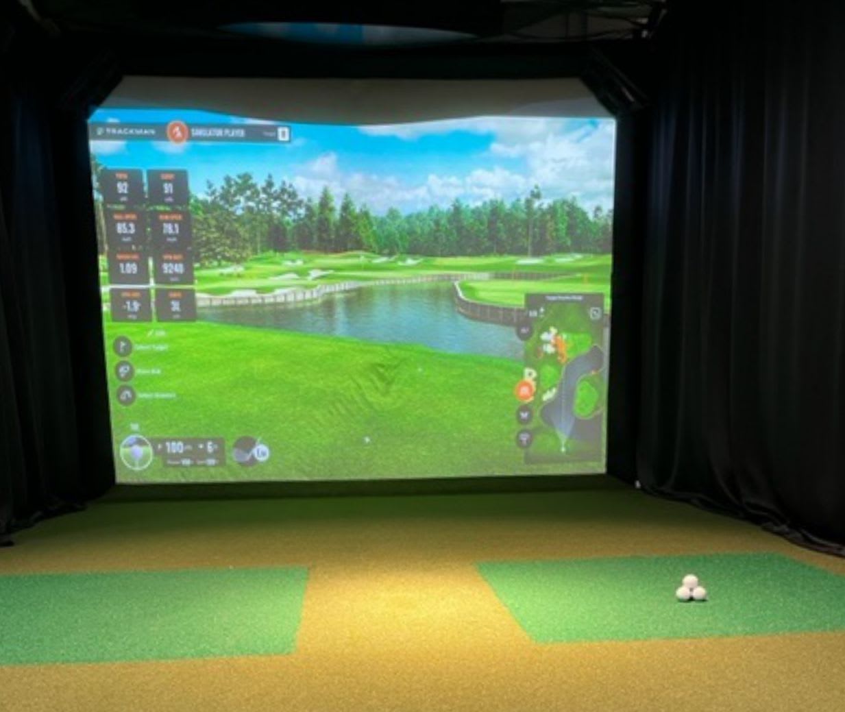 tee line turf shown in front of golf simulator screen